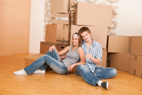 Packed moving boxes and furniture prepared for transport by a removals company