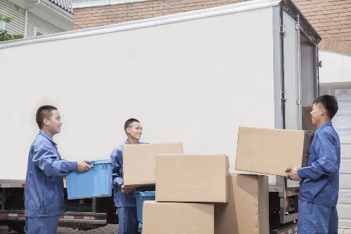 Professional removal services in Chessington handling household moving boxes