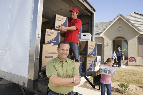 Professional movers packing fragile items for a Chessington house move