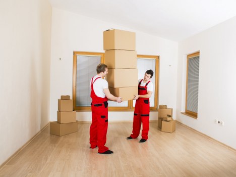Professional movers loading furniture for same day removals